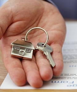 Real estate keys and documents with house models