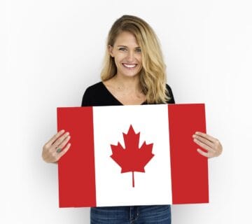 Woman holding a Canada flag for study permits