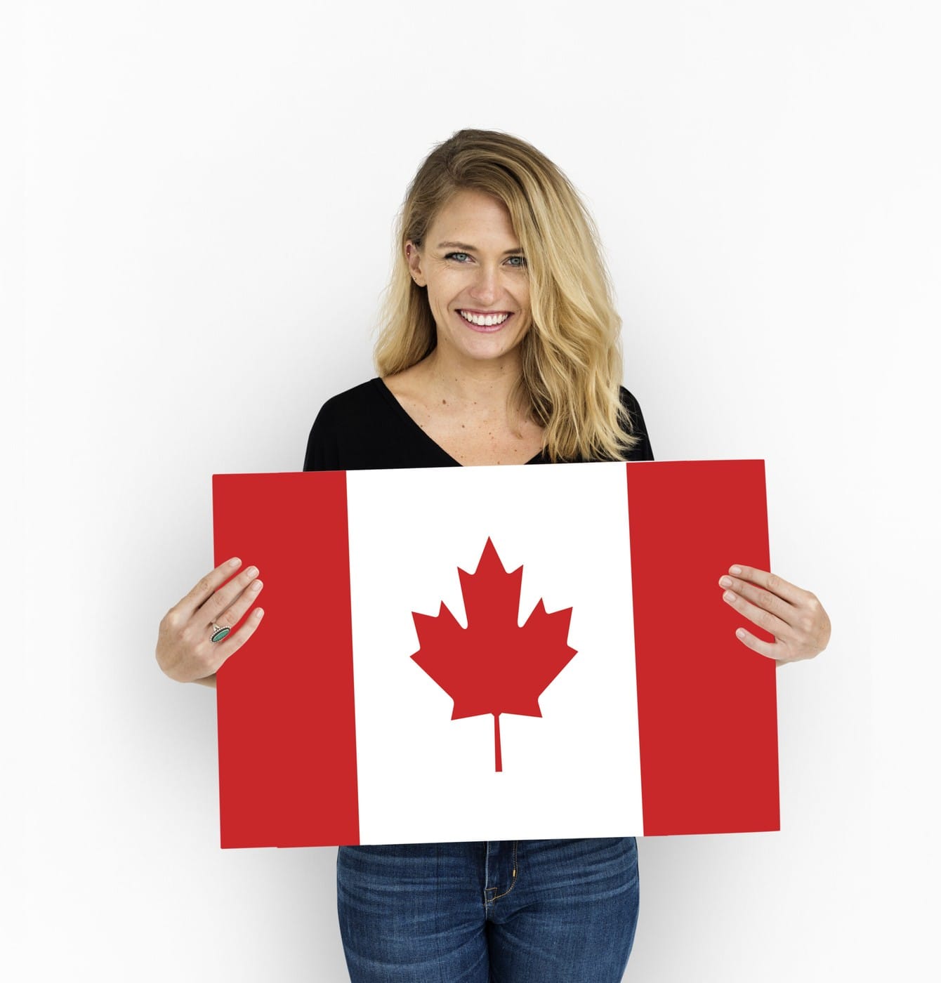 Woman holding a Canada flag for study permits