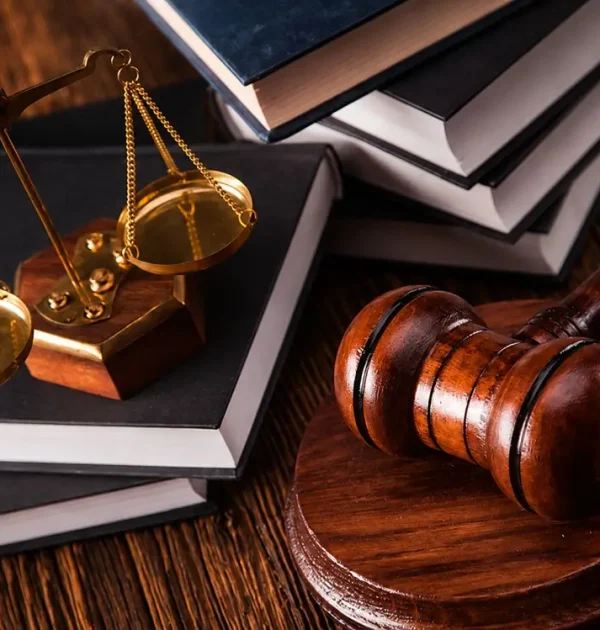 Law office desk with books, legal papers, and scales of justice