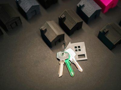 Real estate keys and documents with house models